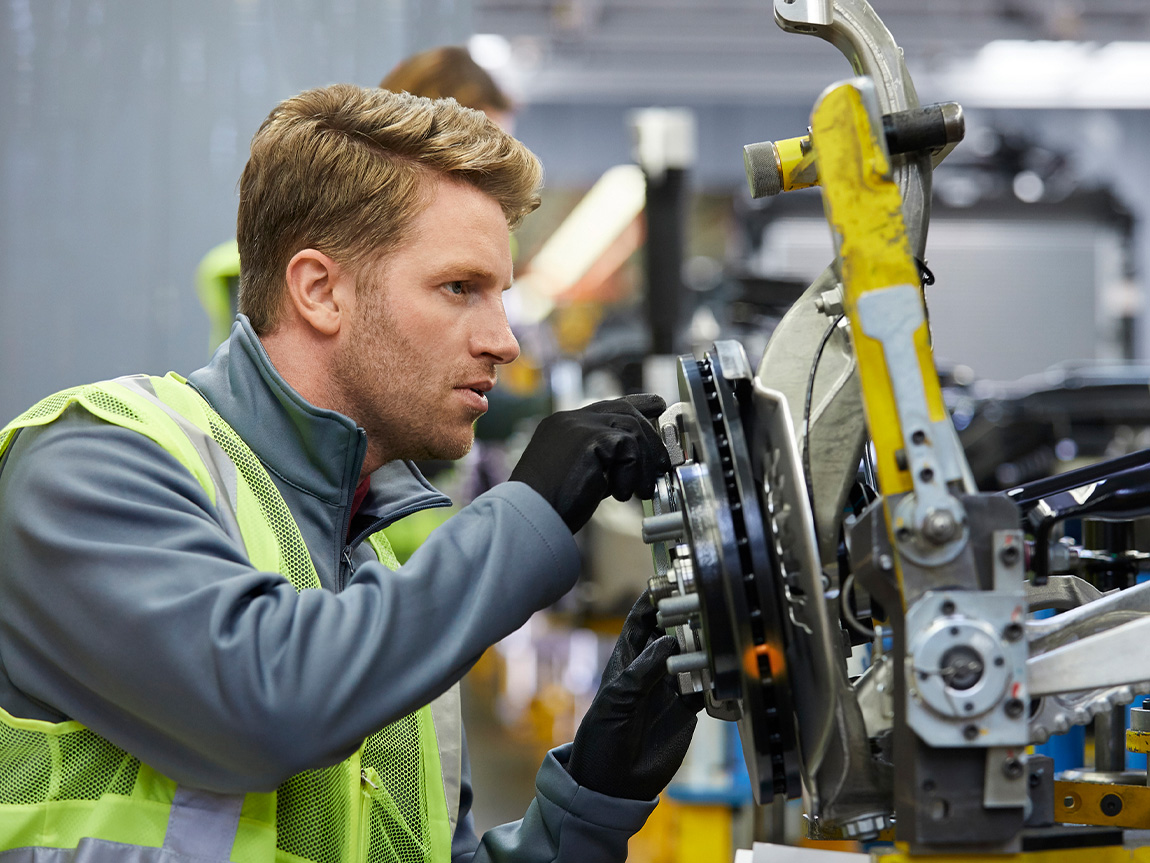 Automotive engineer examines car chassis